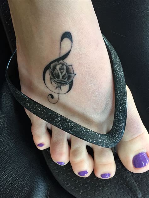 The most common musical tattoos are symbols from sheet music, including different musical notes and symbols, such as the bass and treble clef along with the musical staff that marks the row of sheet music. Music note and rose | Tattoos