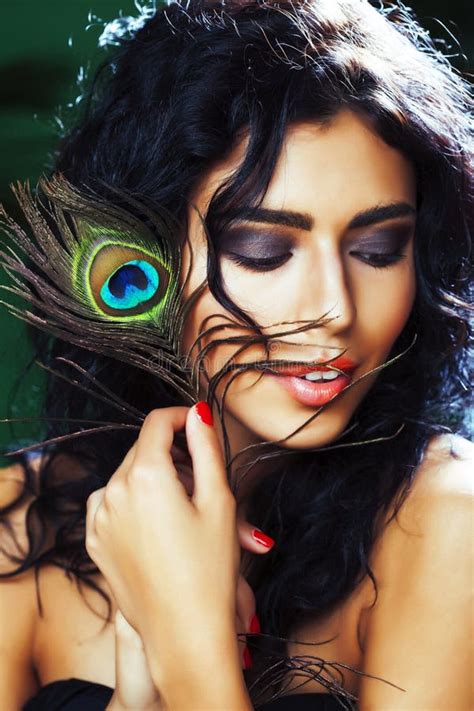 Young Sensitive Brunette Woman With Peacock Feather Eyes Close Up On