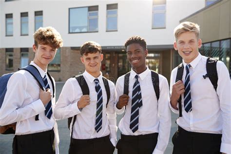 Portrait Of Smiling Male High School Students Wearing Uniform Outside