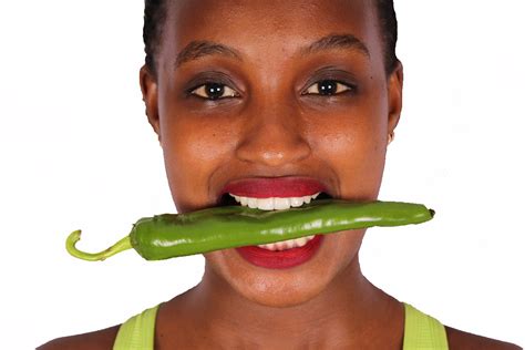 Close Up Woman Bitting Green Pepper