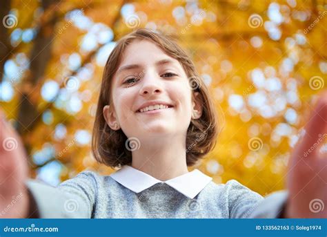 Teen Girl Is Posing Near Tree In Autumn Park Beautiful Landscape At
