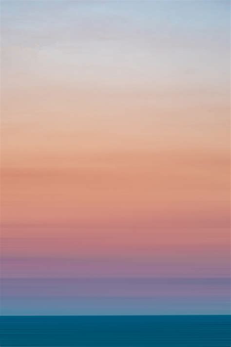 Light Blue Pink Sky Over Silent Ocean At Sunset · Free Stock Photo
