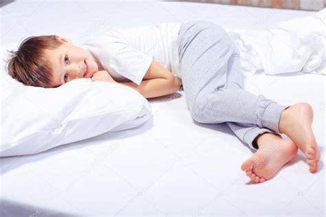 Portrait Of A Boy In Bed With Pajama Stock Photo By ©dmyrtoz 65150551