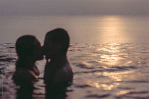 Anonymous Couple Kissing In The Pool At Sunset By Mosuno Summer