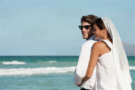 Bride And Groom Embracing At The Beach Stock Photo Dissolve
