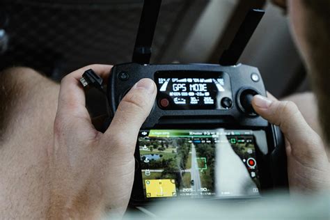 Person Controlling Drone Using Black Remote Control · Free Stock Photo