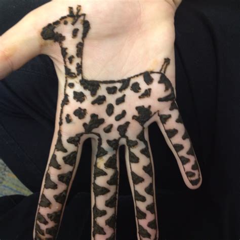A Persons Hand With A Painted Giraffe On It