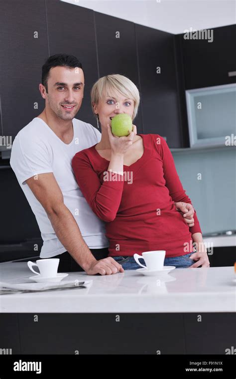Happy Young Couple Have Fun In Modern Kitchen Indoor While Preparing