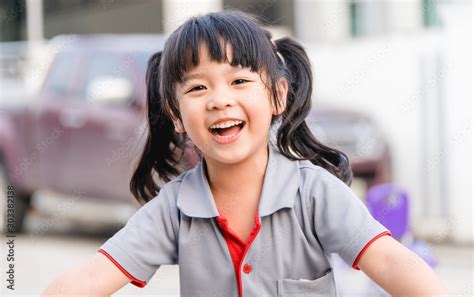 Happy Little Asian Girl Child Showing Front Teeth With Big Smile And