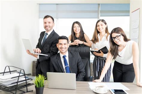 Portrait Of Office Staff Smiling At Desk In Office Stock Image Image
