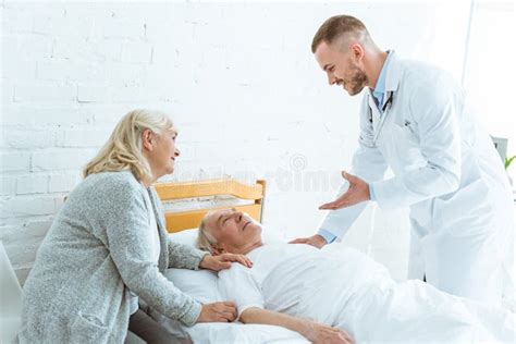 Doctor And Senior Woman Near Ill Patient In Clinic Stock Image Image