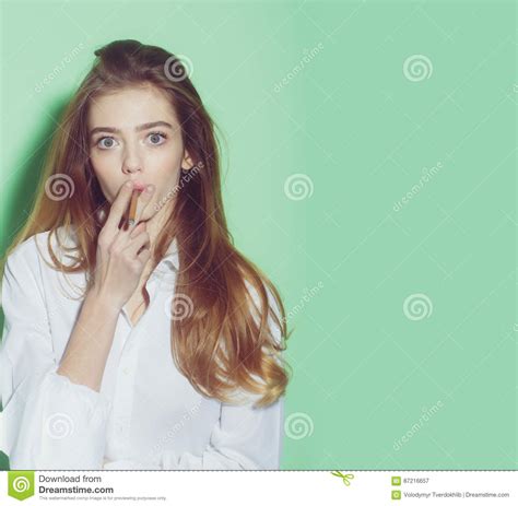 Pretty Woman Or Girl With Long Hair Smoking Cigarette Stock Image