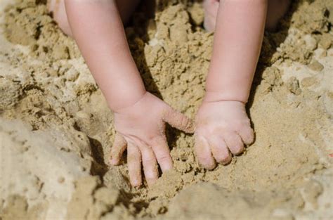 Child Digging In Wet Sand Stock Photos Pictures And Royalty Free Images