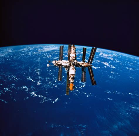 A Space Station In Orbit Above The Earth Photograph By Stockbyte