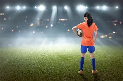 Premium Photo Rear View Of Asian Football Player Woman In Orange