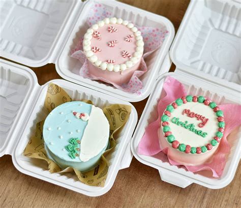 Four Plastic Trays With Decorated Cakes In Them