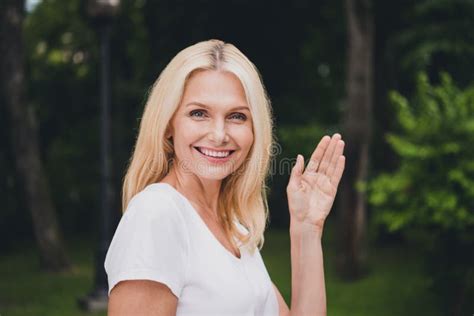 profile photo of mature blond lady wave wear white t shirt in park alone stock image image of