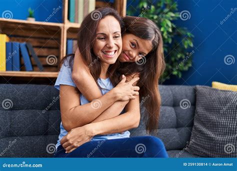 Woman And Girl Mother And Daughter Hugging Each Other At Home Stock