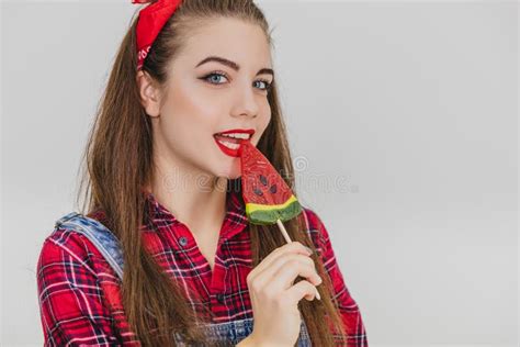 Pretty Pinup Girl Standing Licking Red Heart Shape Lolly Pop Pleased Face Expression Stock