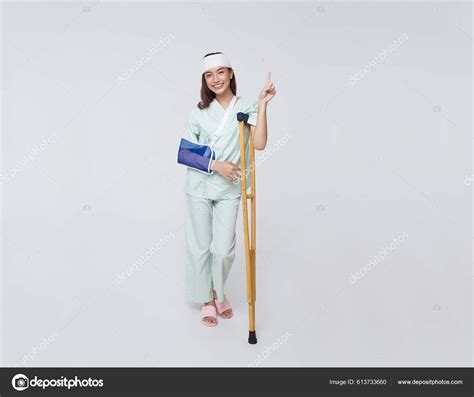 Asian Teenage Woman Wearing Patient Gown Put Cast Use Crutch Stock
