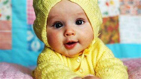 Cute Baby Is Wearing Yellow Knitted Wool Dress Lying Down