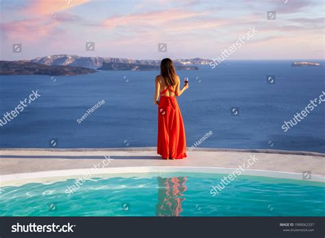 Beautiful Woman Red Dress Stands By Stock Photo 1988062337 Shutterstock