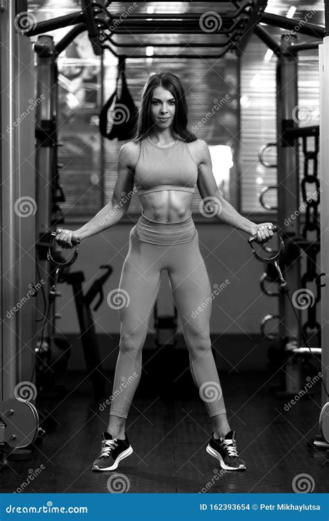 Fitness Brunette Woman Is Doing Exercises On Crossover In The Gym Bw Stock Photo Image Of