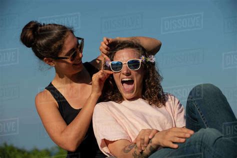 Two Women Laughing Outside On A Sunny Day Stock Photo Dissolve