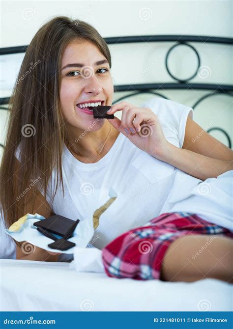 Teenage Brunette Enjoying Chocolate Bar In Bed Stock Image Image Of