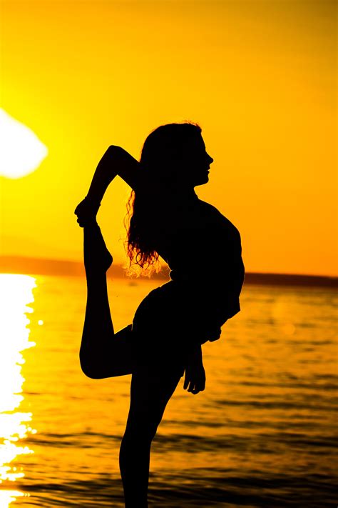 Woman Stretching At Sunrise On The Beach Image Free Stock Photo