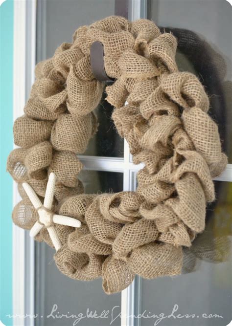 First, fold the end of a burlap strip into quarters lengthwise. Easy DIY Burlap Wreath Tutorial | Living Well Spending Less®