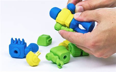 A Person Is Playing With Plastic Toys On A White Surface And There Are
