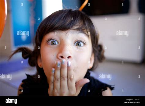 Mixed Race Girl With Hand Over Mouth Stock Photo Alamy