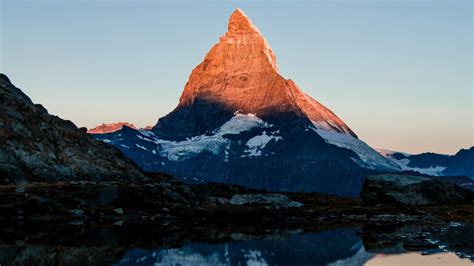 Download 1366x768 wallpaper matterhorn, mountain, glow, sunset, lake ...