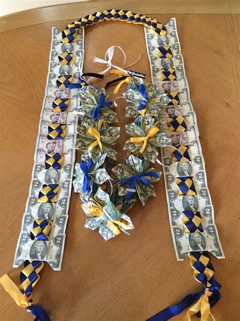 More diy lei tutorials i've shared that are perfect for graduation leis, including a money lei tutorial with a ribbon lei, a three color ribbon lei and a 4 ribbon double braided ribbon lei. UCLA-UCI Grad Money Ribbon sash! | Diy graduation gifts, Graduation money gifts, Creative ...