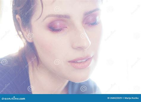 Overexposed Portrait Of A Woman With Eyes Closed And Tender Expression