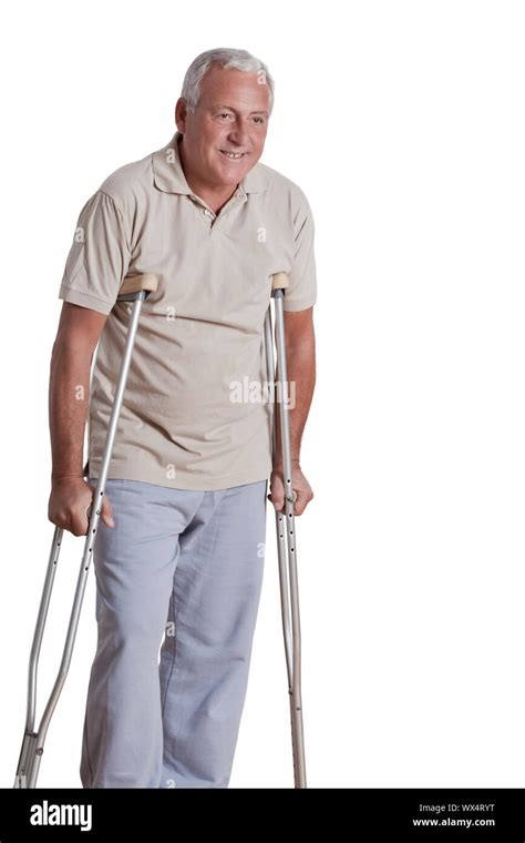 Senior Man With Crutches And Females Doing Physical Exercise Stock