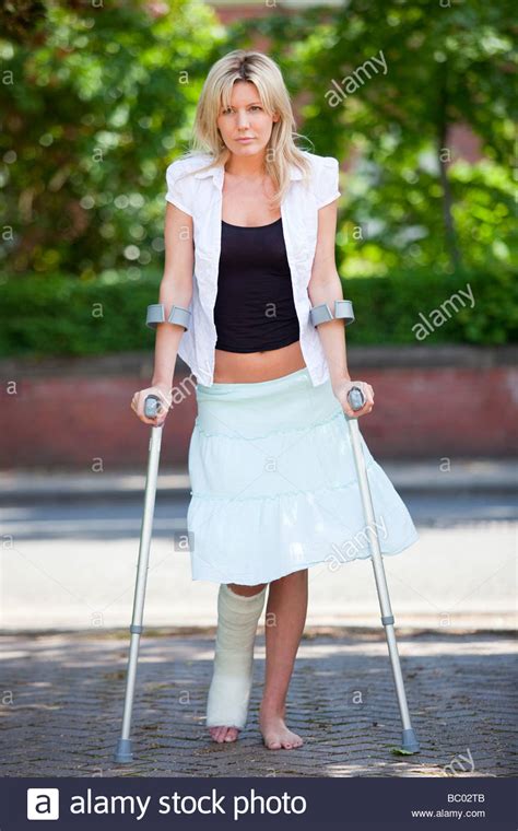 Woman Walking On Crutches Stock Photo 24588491 Alamy