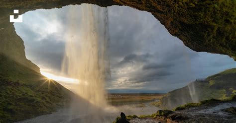 A View Of A Waterfall From Inside A Cave Photo Free Nature Image On