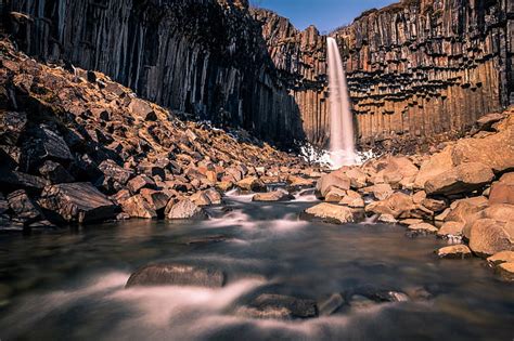 Waterfall Between Rocks During Daytime 4k 5k Hd Nature A Waterfall