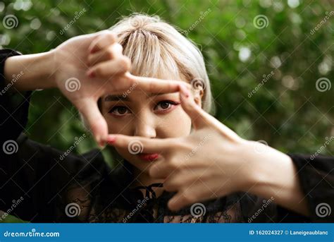 Closeup Of Young Adult Blond Asian Girl Making Frame Gesture Stock Image Image Of Hands Face