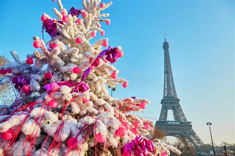 Christmas Tree Covered With Snow Near The Eiffel Tower In Paris Stock