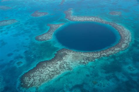 The great blue hole is a large circular submerged sinkhole off the coast of belize. Great Blue Hole, Belize | 83 Unreal Places You Thought ...