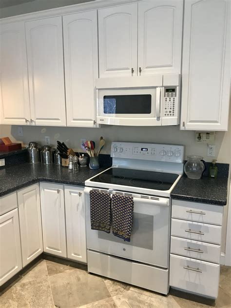 The bright white, chantilly lace paint color tied them into the existing wainscoting and trim in the room. Chantilly Lace Oak Kitchen - 2 Cabinet Girls