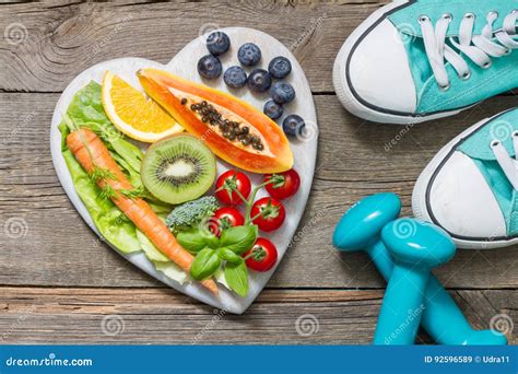 Healthy Diet And Sport Concept With Dumbbells Trainers And Food Stock