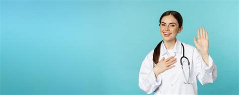 Premium Photo Friendly Smiling Woman Doctor Raising Hand Name Herself
