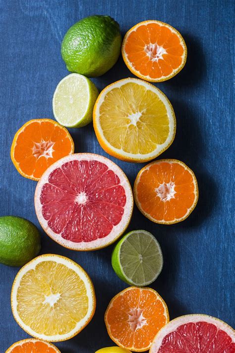 Assortment Of Citrus Fruits On A Blue Background Top View Oranges