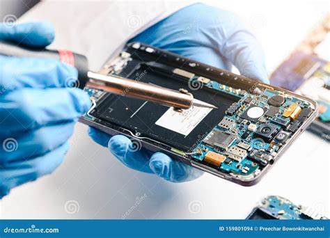 The Technician Repairing The Smartphone S Motherboard In The Lab By