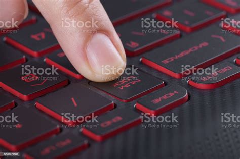Finger Pushing Num Lock Button On Laptop Keyboard Stock Photo