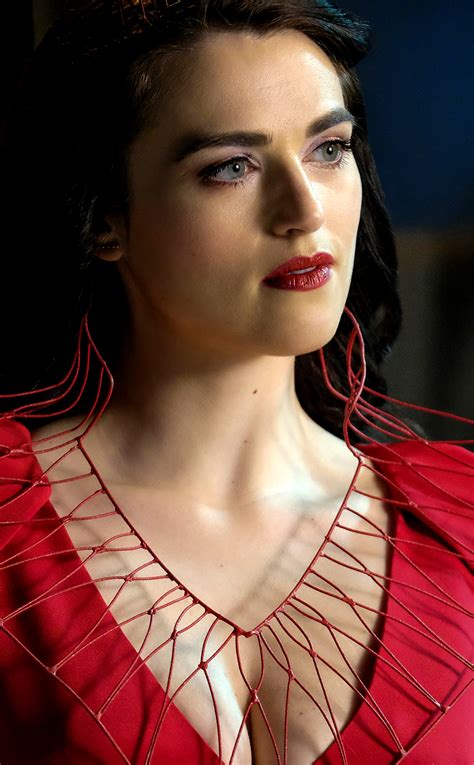A Woman In A Red Dress With Large Metal Hoop Earrings On Her Neck And Chest